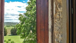 A view through an open wooden door to a lush green landscape with a clear sky. - 1 bedroom nice home in Carnas (Carnas)