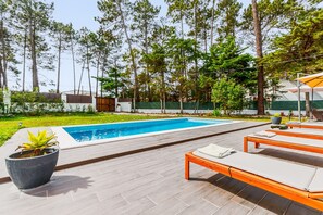 A swimming pool with lounge chairs and a potted plant. - Holiday Home 'Vila Das Manas' with Private Pool, Private Garden and Wi-Fi (Verdizela)