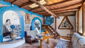 A rustic interior with stone walls, wooden furniture, and traditional decor.