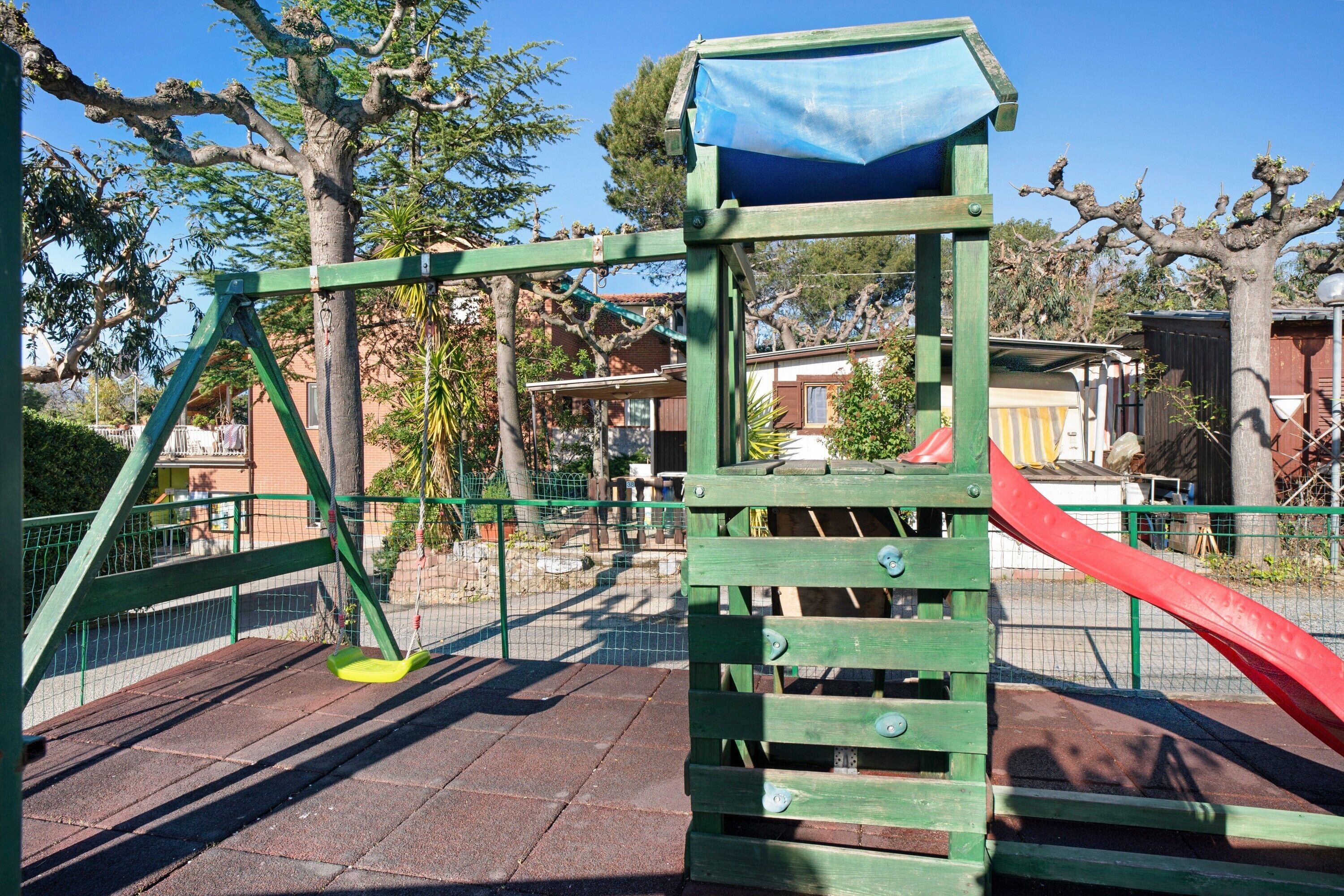 A playground with a swing set and a slide.