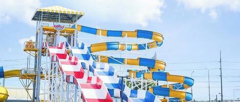 A water park with multiple water slides and a pool.