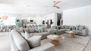 A modern living room with two sofas, a coffee table, and a dining area with chairs. - Beautiful Villa with First Class Amenities in Reunion Resort, Orlando Villa 1011 (Orlando)