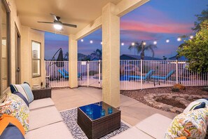 A covered outdoor patio with a pool, lounge chairs, and a ceiling fan. - Orange Blossom Hideaway * Sparkling Heated Pool, Outdoor Seating (Phoenix)