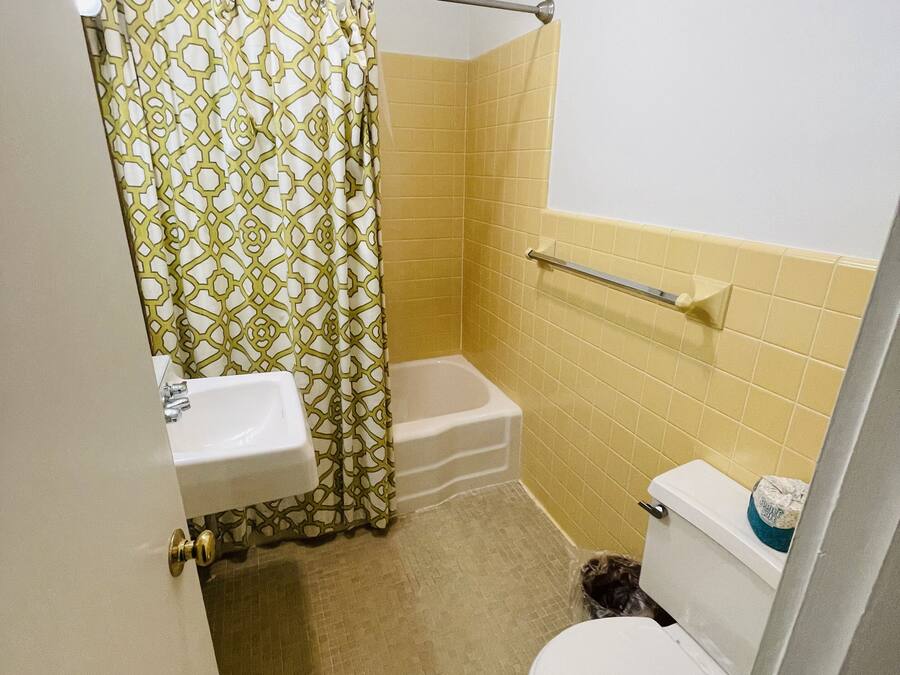 A small bathroom with a toilet, sink, and bathtub.