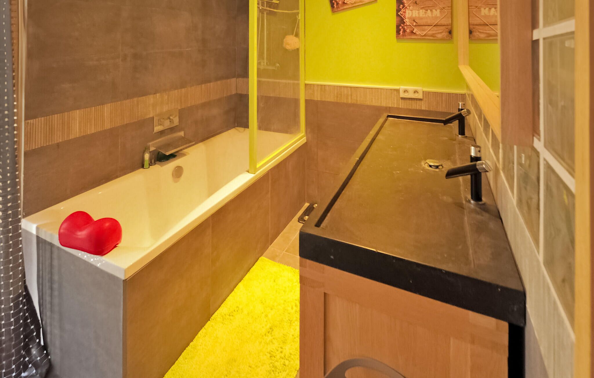 A bathroom with a bathtub, a sink, and a mirror.