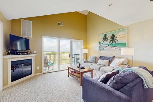 Bethany Bay condo with bay views, athletic courts, pool, fireplace, & balcony