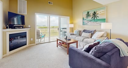 Bethany Bay condo with bay views, athletic courts, pool, fireplace, & balcony