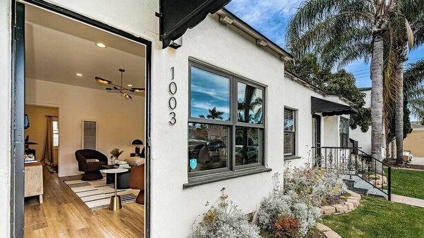 A modern house with a number '1003' on the wall, a well-maintained garden, and a visible interior with a sofa and a dining area. - Dahlia Suite I Steps to Bay, Shops, Food + More (Coronado)