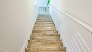A wooden staircase with white walls and a light fixture at the top. - New Cozy SanDestin Beach TownHome/30A (Santa Rosa Beach)