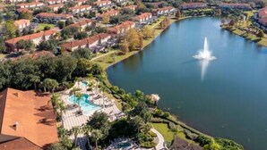 Un quartier résidentiel avec des maisons, un lac et une piscine.
