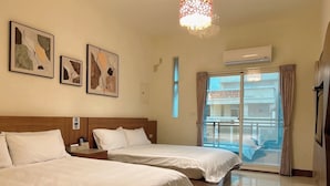 A hotel room with two beds, a chandelier, artwork on the wall, an air conditioning unit, and a view through the window. - Secret base B&B (Taitung)
