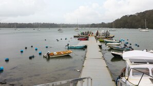 A marina with boats docked and floating buoys in the water.