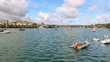 A harbor with multiple boats and a small inflatable boat in the foreground.