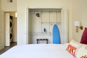 Cozy retreat with a comfortable bed, laundry facilities, and ample storage.