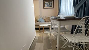 Deluxe Studio | Living area | Flat-screen TV