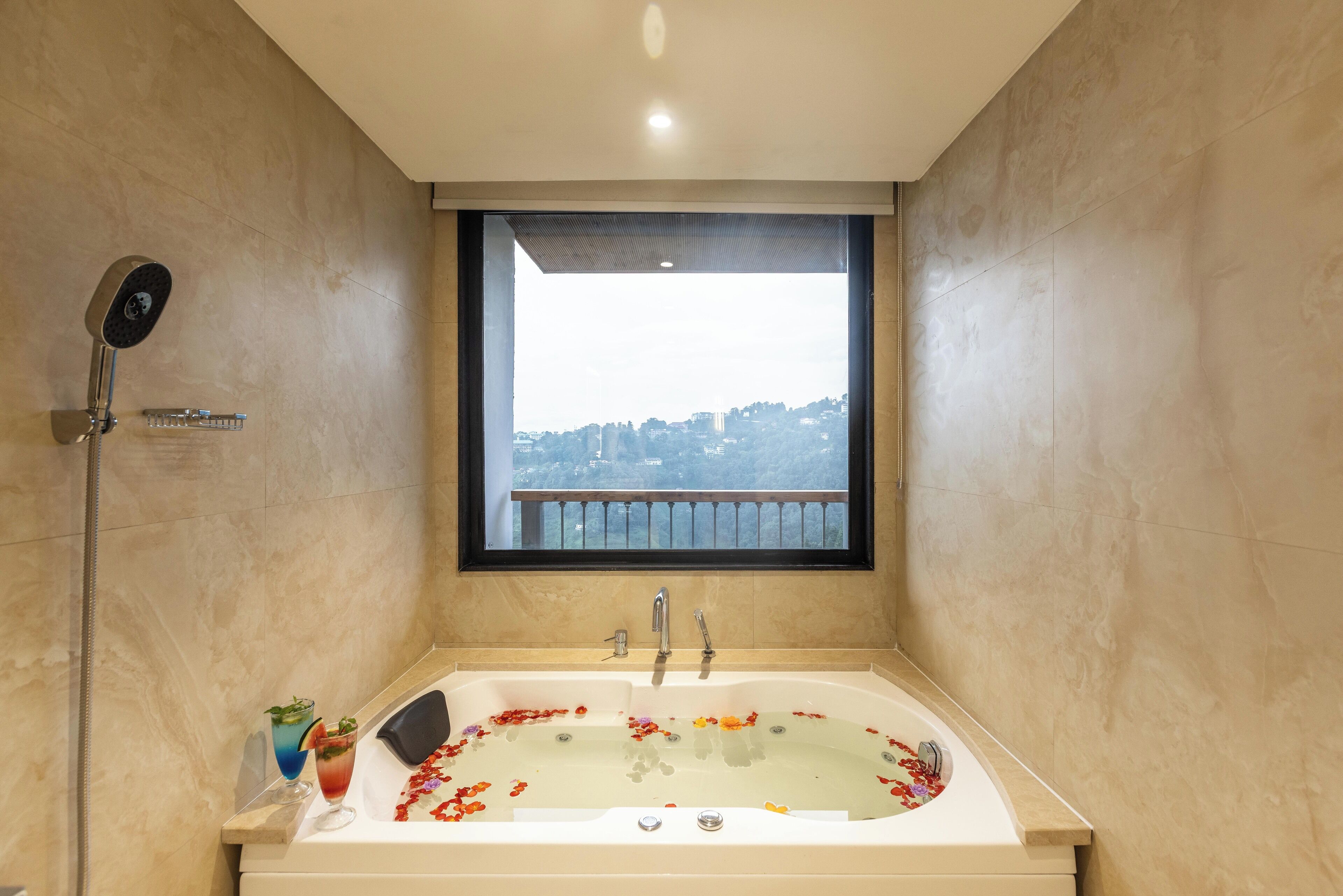 A bathroom with a bathtub, a shower, and a window with a view of a balcony.