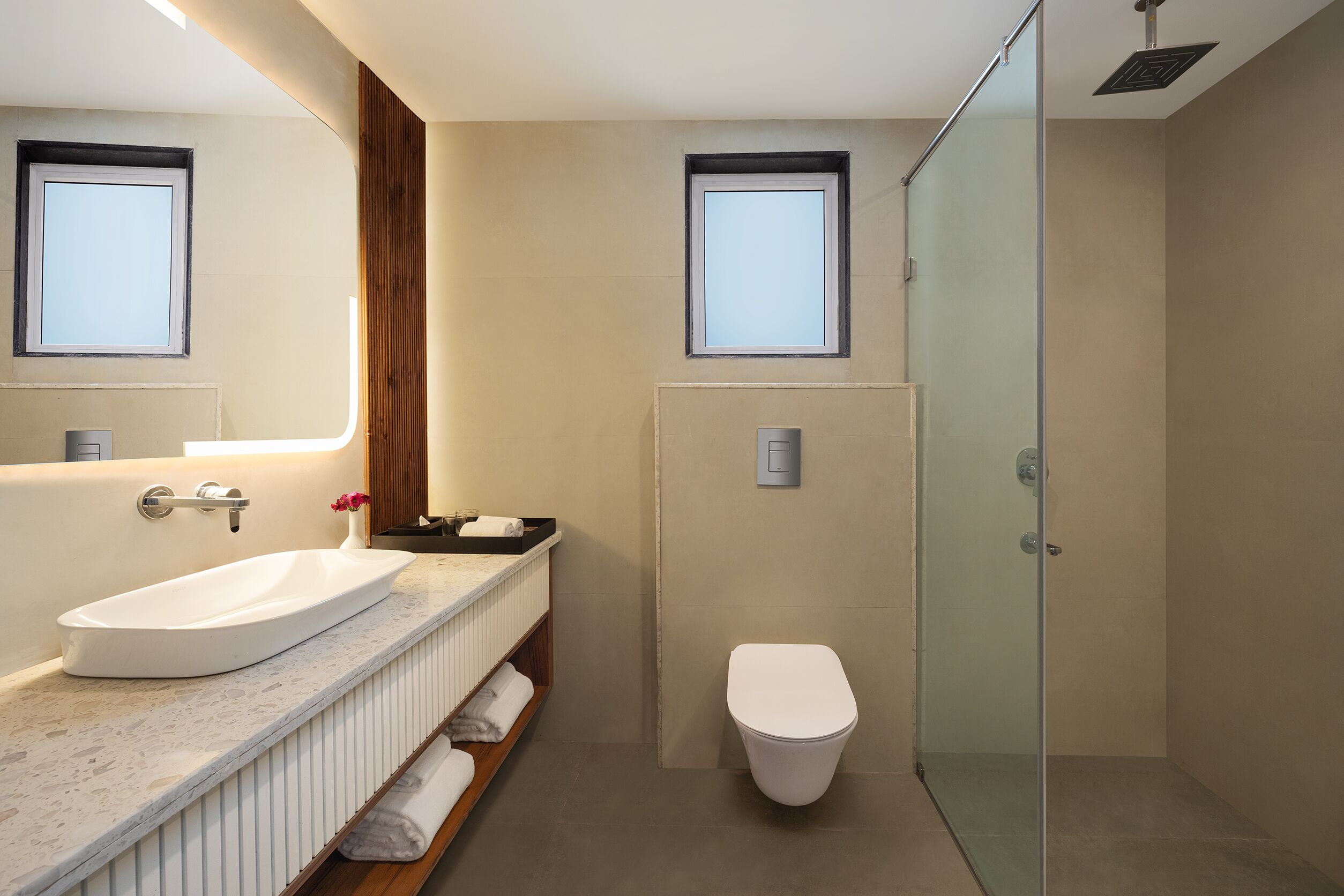 A modern bathroom with a freestanding bathtub, a glass-enclosed shower, and a toilet.
