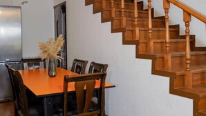 A dining area with a wooden staircase. - Restland Dilijan Family Hotel  (Dilijan)
