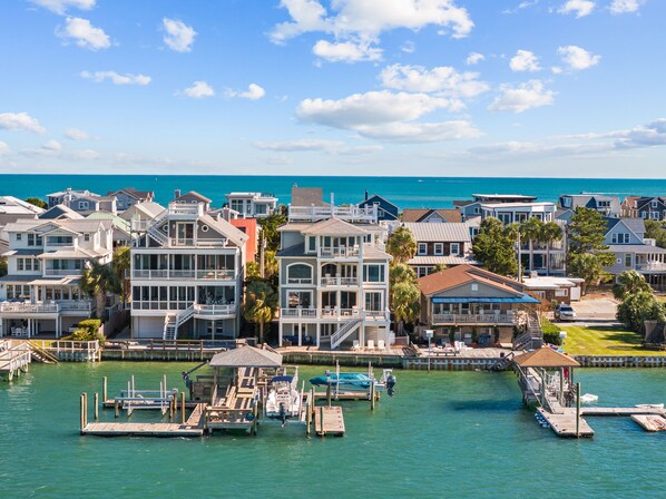 A coastal residential area with houses, docks, and a marina.