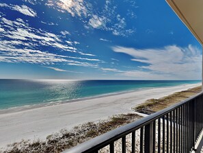 A beach view from a balcony with a railing, clear sky, and ocean. - Sundunes #172 | Stunning Views & Pool Access + Near Local Fun! (Navarre Beach)