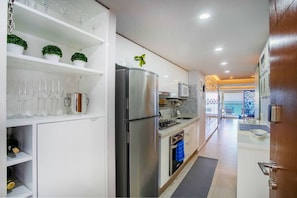 The kitchen is well-stocked with multiple glass wines for a delightful evening