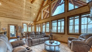 A spacious living room with a high ceiling, large windows, and a cozy fireplace. - Sunglow Mt Vista - Pet friendly-Mountain View- Hottub-  (Cherrylog)