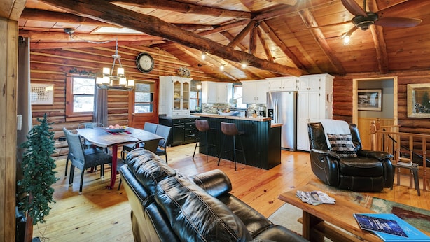 A log cabin interior with a dining area, kitchen, and living space. - The Rexford Cabin: Easy Drive to PA Grand Canyon! (Gaines Township)