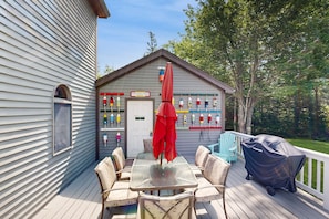 Enjoy al fresco dining on the deck with a covered table and chairs, grill, and stunning views of Beach Point Beach.
