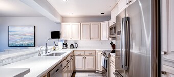 Lakefront condo with mountain views, pool, balcony, grill, fireplace, streaming