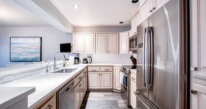 Lakefront condo with mountain views, pool, balcony, grill, fireplace, streaming