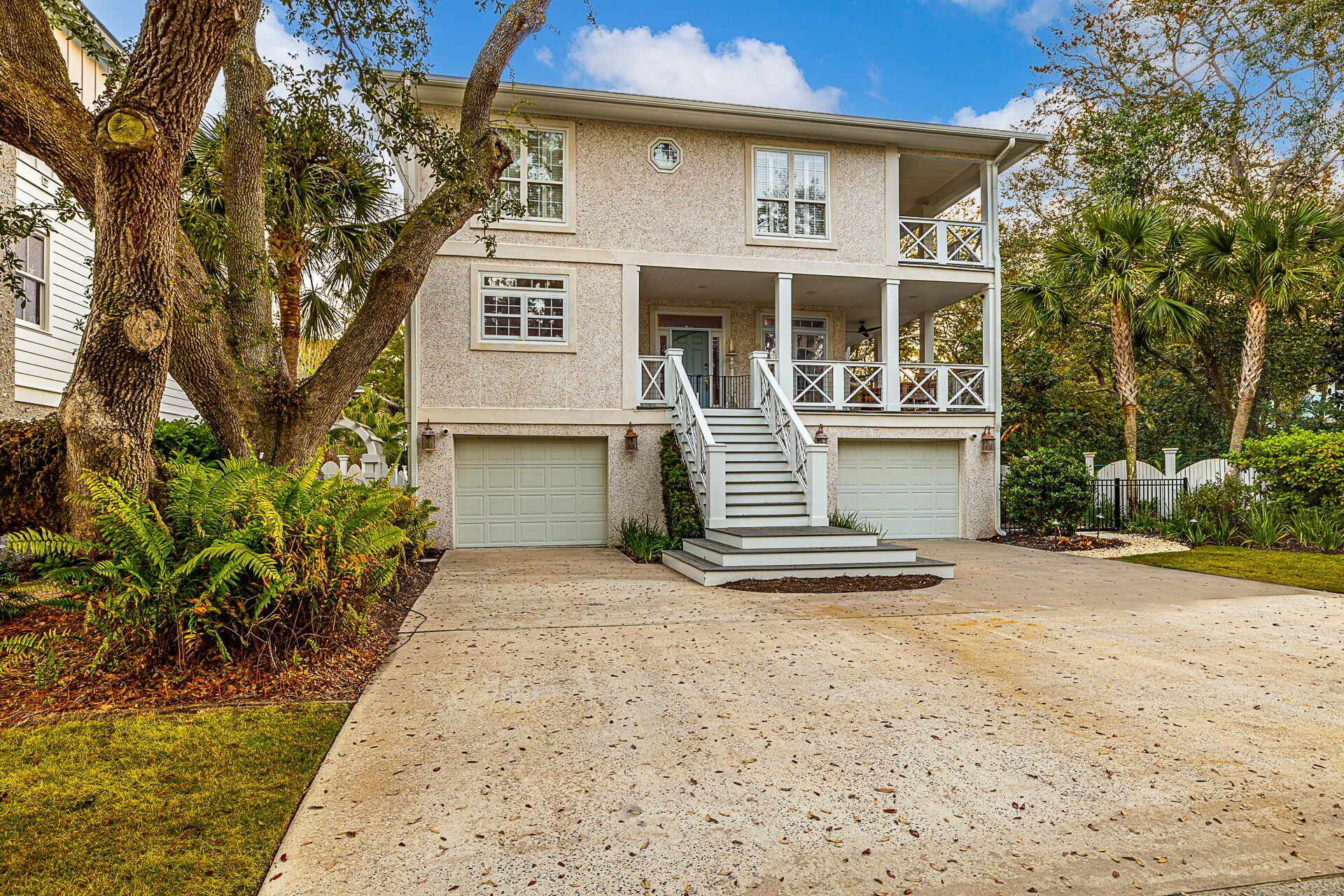 A two-story house with a front porch, a garage, and a driveway.