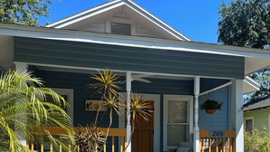 A two-story house with a porch, a mailbox, and a number sign. - Relaxing 2-bedroom cottage in beautiful Sanford  (Sanford)