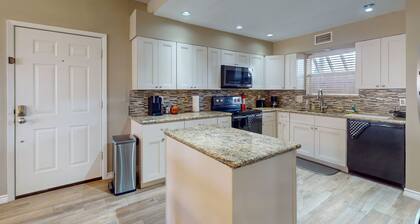 Waterfront community condo with on-site pool, water views, & private patio