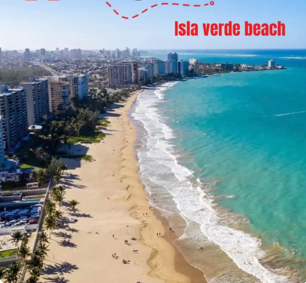 Un paisaje urbano costero con playa, edificios altos y cielo despejado.