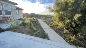 A garden pathway leading to a building with a patio area. - New Private Studio - UCR - LLU (Riverside)