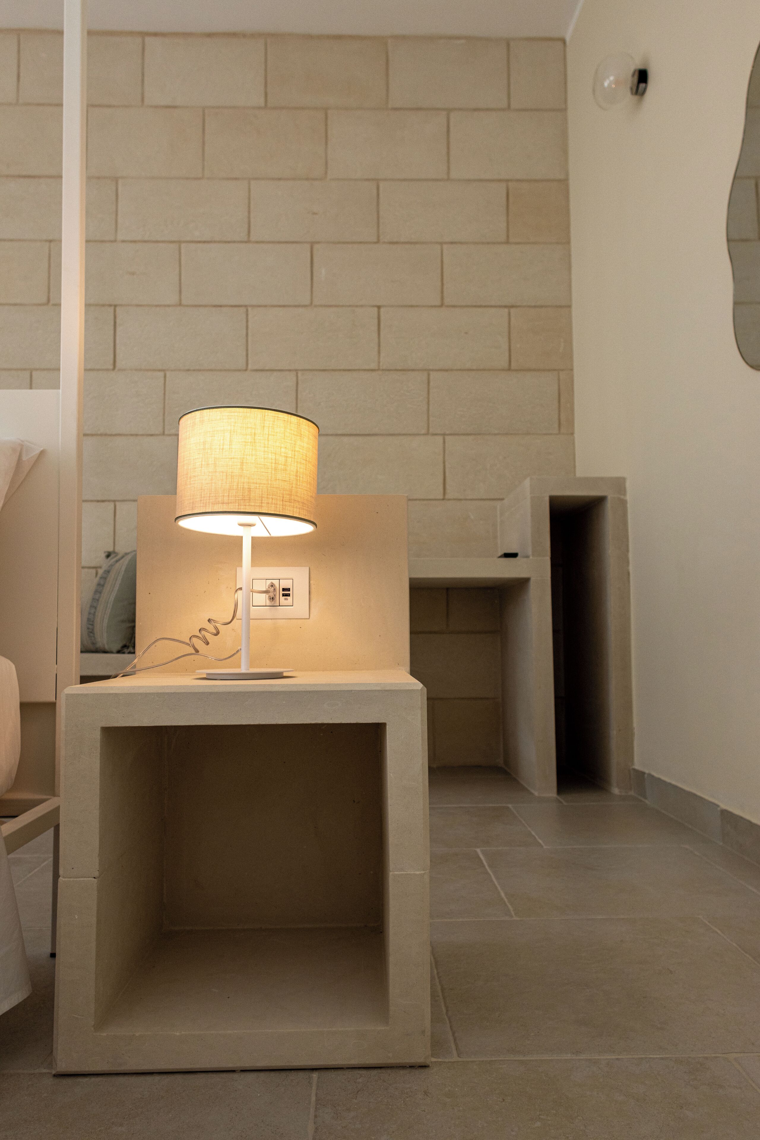 A modern bathroom with a built-in sink, a towel rack, and a wall-mounted mirror.