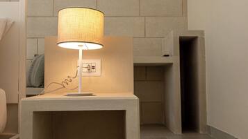 A modern bathroom with a built-in sink, a towel rack, and a wall-mounted mirror.