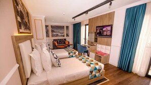 A hotel room with a large bed, a desk, a chair, and a television. - Hotel Atlantis Alger (Algiers)