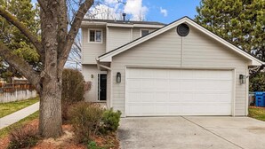 A single-story house with a garage, a front door, and a small porch area.