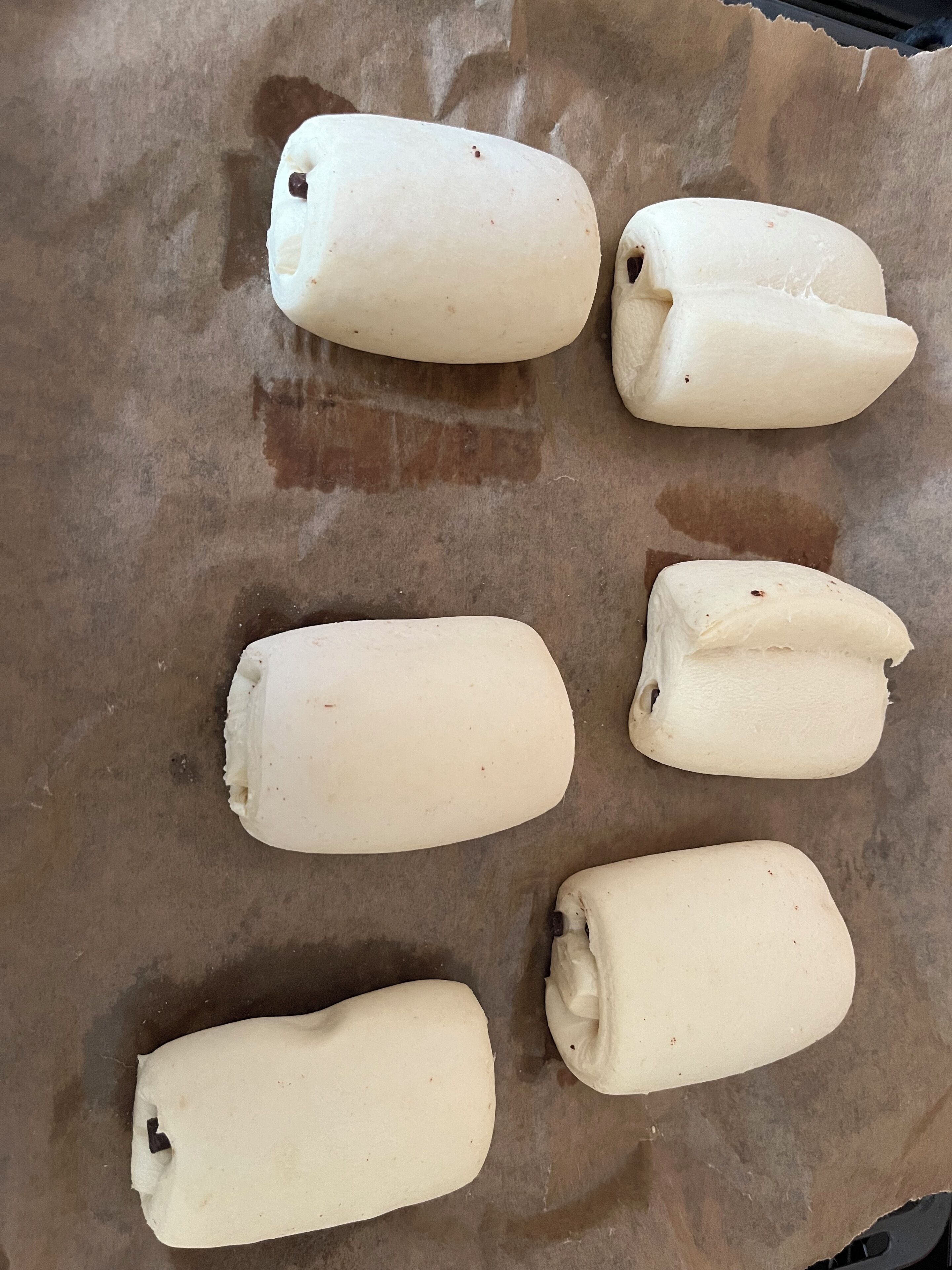 Six cylindrical objects on parchment paper.