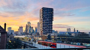 Une vue urbaine avec des bâtiments modernes, un tramway et une gare.