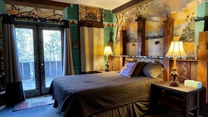 A hotel room with a bed, two bedside tables with lamps, a ceiling fan, and a view of the outdoors through a door. - Spacious 5-bedroom Lodge nestled at the Gateway to the Sequoias.  (Three Rivers)