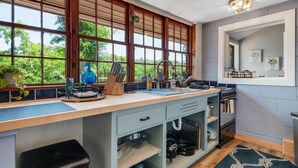 A modern kitchen with large windows, a built-in stove, and a sink. - Waterfront on Lake Talquin - Free Kayaks - Near FSU - 2 Story Dock - Fire Pit (Tallahassee)