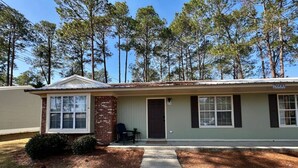 A single-story house with a front porch, a brick section on the left, and a number '2600' on the right. - Southern Travel - Charming 3 BR (Moultrie)