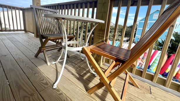A wooden deck with two wooden chairs and a small table. - Wimble Shoals Chateau - Studio in Salvo above Surf Shop- (Salvo)