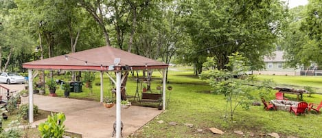 Covered private parking for two with extra space in the drive. Shaded by trees, flowers, and our nearby chicken coop.