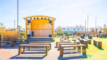 Relax in our outdoor event space, featuring a stage and comfortable seating for gatherings.