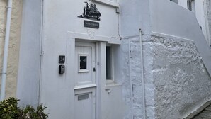 A building with a white facade, a door labeled "WINDJAMMER," and a small window above the door.