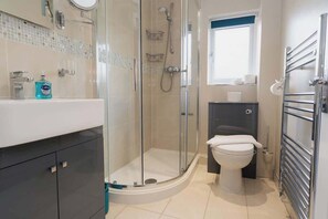 Shower, hair dryer, towels, shampoo