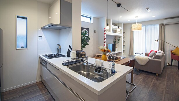 A modern kitchen with a central island, built-in oven, and stainless steel sink. - Travel time Koji Higashi 4LDK Max8ppl (Osaka)